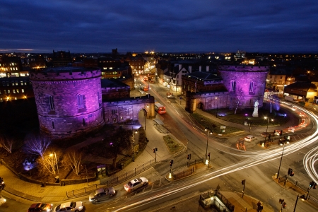 Skyline illuminated city view of Rush hour traffic at Carlisle citadel built in 1541 by Henry VIII to strengthen the south of the city the two towers were re built in 1810の写真素材