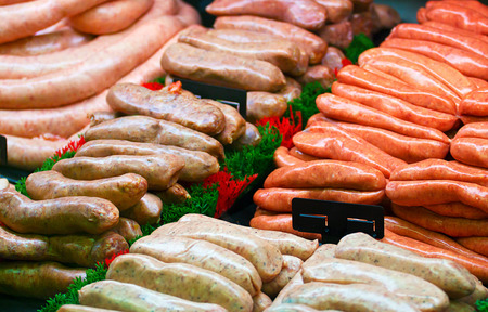 Selection of speciality sausages on display at a butchers counter or delicatessen windowの写真素材