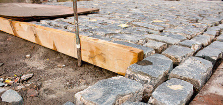 Traditional Cobble stone paving being layed by building contactorの写真素材