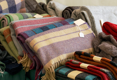 Selection of throws traditionally made of wool in a pile for sale at market traders, great example...