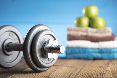 Fitness concept - objects and food on wooden tableの写真素材