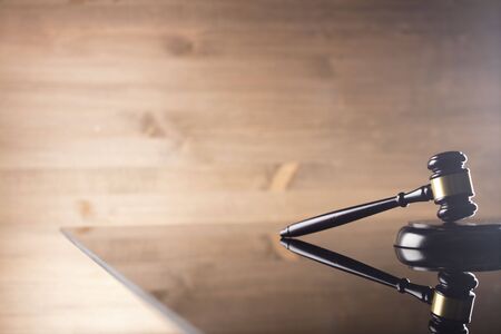 Gavel of the judge on the brown wooden backgroundの写真素材