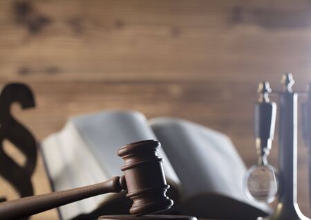 Law theme, gavel and legal code on wooden table
