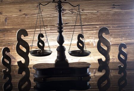 Law and justice concept - scale and legal code paragraph symbol on wooden background