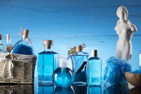 Spa concept  - Venus de Milo statue and bottles with cosmetics on glass table