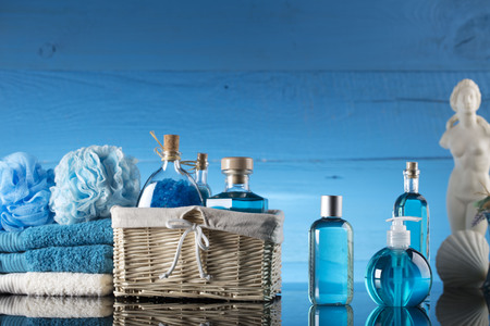 Spa concept – Venus de Milo statue and bottles with cosmetics on glass table