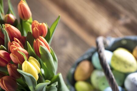 Easter theme. Bouquet of tulips. Easter eggs. Colorful bokehの写真素材