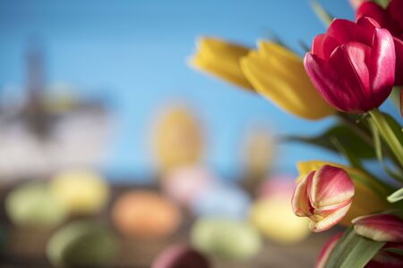 Easter theme. Bouquet of tulips. Easter eggs. Colorful bokehの写真素材
