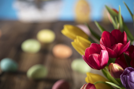Easter theme. Bouquet of tulips. Easter eggs. Colorful bokehの写真素材