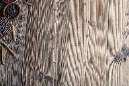 Set of colorful spices in bowls on wooden table.の写真素材