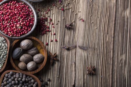 Set of colorful spices in bowls on wooden table.の写真素材