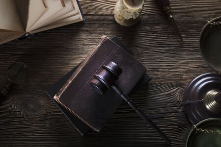 Law and justice theme. Mallet of judge. Legal code. Wooden table. Top view.の写真素材