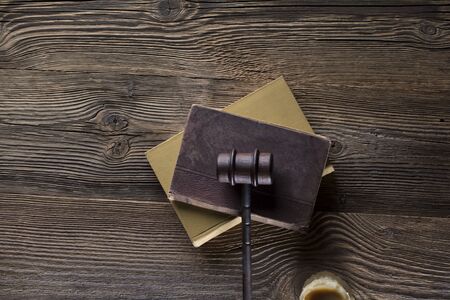 Law and justice theme. Mallet of judge. Legal code. Wooden table. Top view.の写真素材