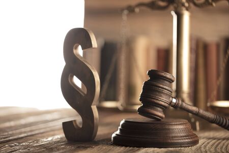 Law and justice theme. Mallet of judge and scale of justice. Legal code. Wooden table.の写真素材