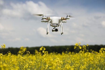 Dron in action. Rape field scenery. Summer time. Backgrounds concept.の写真素材
