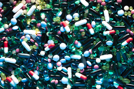 Pharmacy theme.  Set of different colorful pills on glass table. Background concept.の写真素材