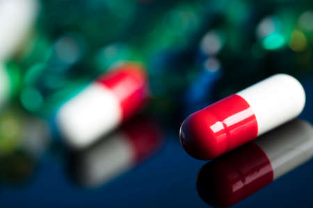 Pharmacy theme.  Set of different colorful pills on glass table. Background concept.の写真素材