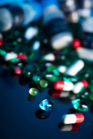 Pharmacy theme.  Set of different colorful pills on glass table. Background concept.の写真素材