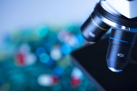 Pharmacy theme.   Set of different colorful pills and microscope. Background concept.