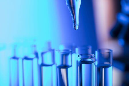 Laboratory theme.  Laboratory experiment. Test tubes. Scietific lab concept. Blue background.