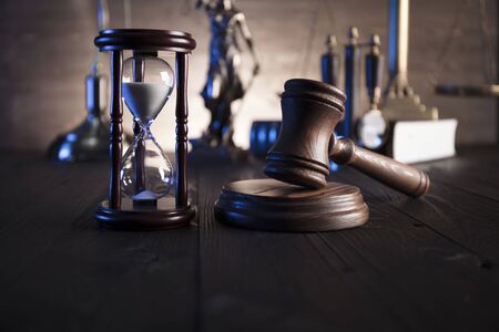 Law and justice theme. Mallet of judge and scale of justice.  Wooden table.の写真素材