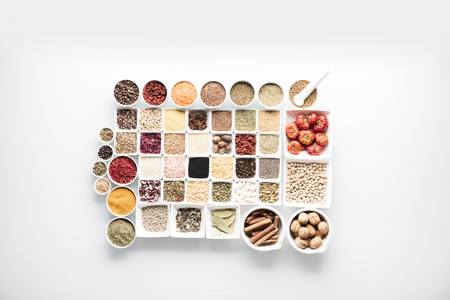 Spices and leguminous vegetables in bowls, isolated on white backgroundの写真素材