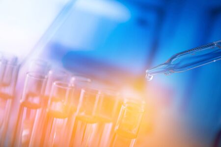 Lab experiment. Laboratory concept background. Tubes during experiment in laboratory. Colorful bokeh.の写真素材