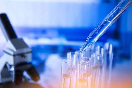 Lab experiment. Laboratory concept background. Tubes during experiment in laboratory. Colorful bokeh.の写真素材