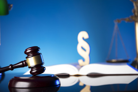 Lawyer, counselor office. Consultation with a lawyer concept. Gavel of the jugde and scale of justice on glass table and blue background.の写真素材