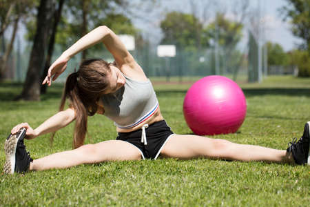 Fitness concept. Woman in the  park during jogging and gymnastic exercises.の写真素材