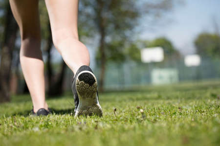 Fitness concept. Woman in the  park during jogging and gymnastic exercises.の写真素材