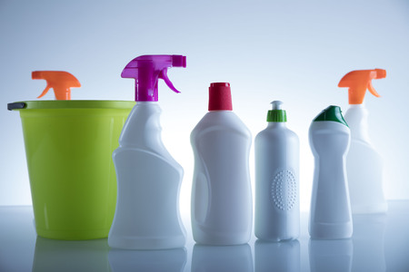 Spring cleanup theme. Variety of  house cleaning products on white table and background.の写真素材