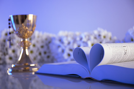 First Holy Communion. Catholic religion theme. Crucifix, Bible, bread isolated on white table and white background.の写真素材