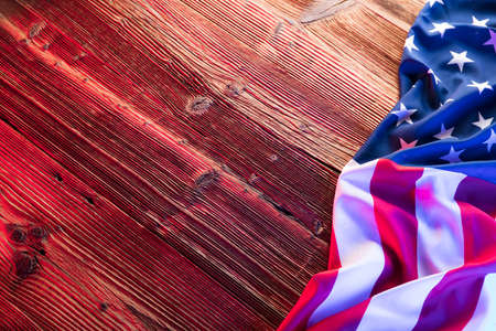 Independence Day concept. American flag on the wooden rustic table.