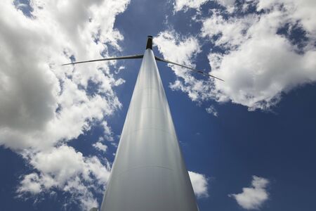 Renewable energy. Farm of wind turbines on the corn field.
