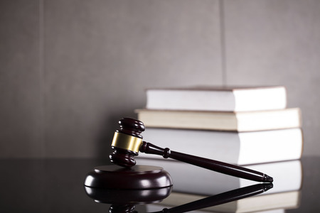 Gavel and books. Law and justice concept. Gray background.