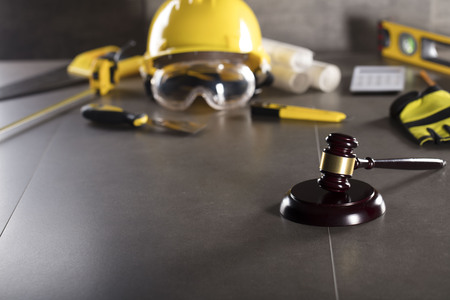 Construction law. Helmet and gavel. Stone table.の写真素材