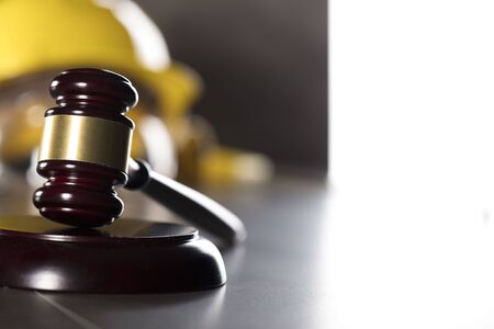 Construction law. Helmet and gavel. Stone table.の写真素材