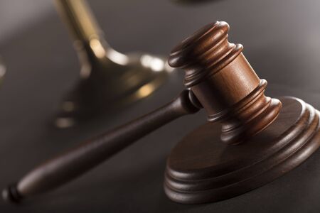 Judge concept. Gavel. Golden scale of justice.  Gray stone background. Place for typography.