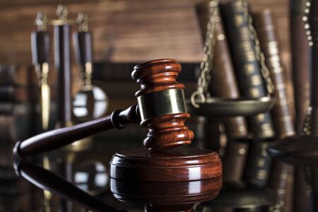 Mallet of judge, legal code and scale of justice in the court library