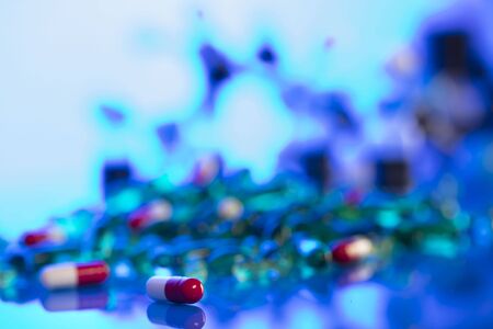 Pharmacy theme.  Set of different colorful pills on glass table.の写真素材