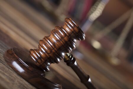 Law concept. Gavel on wooden table and brown background.の写真素材