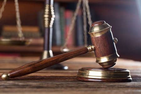 Law and justice concept - gavel of judge and scale of justice on wooden tableの写真素材