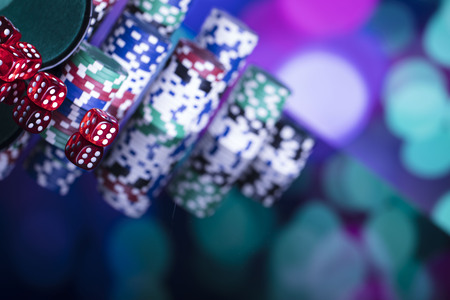 Chips and dice on colorful bokeh.の写真素材