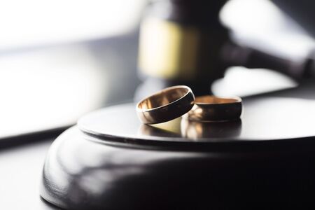 Divorce law concept. Wedding ring and gavel.の写真素材