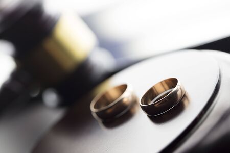 Divorce law concept. Wedding ring and gavel.の写真素材