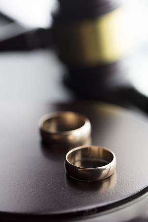 Divorce law concept. Wedding ring and gavel.の写真素材