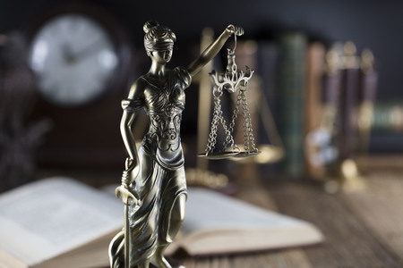 Old court library. Vintage clock. Statue of justice