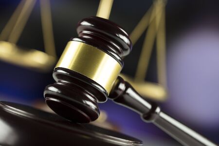 Gavel and scales on bokeh background.