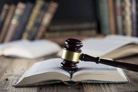 Judge concept. Mallet of the judge and books on wooden desk.の写真素材